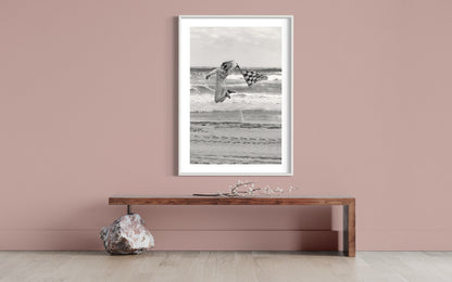 Dynamic Start at TROG: Adrenaline-Packed Flag Girl Soars Over Beach - Breathtaking Black & White Energy Photo Poster Print