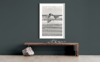 Dynamic Start at TROG: Adrenaline-Packed Flag Girl Soars Over Beach - Breathtaking Black & White Energy Photo Poster Print