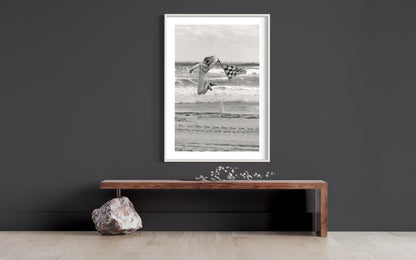 Dynamic Start at TROG: Adrenaline-Packed Flag Girl Soars Over Beach - Breathtaking Black & White Energy Photo Poster Print
